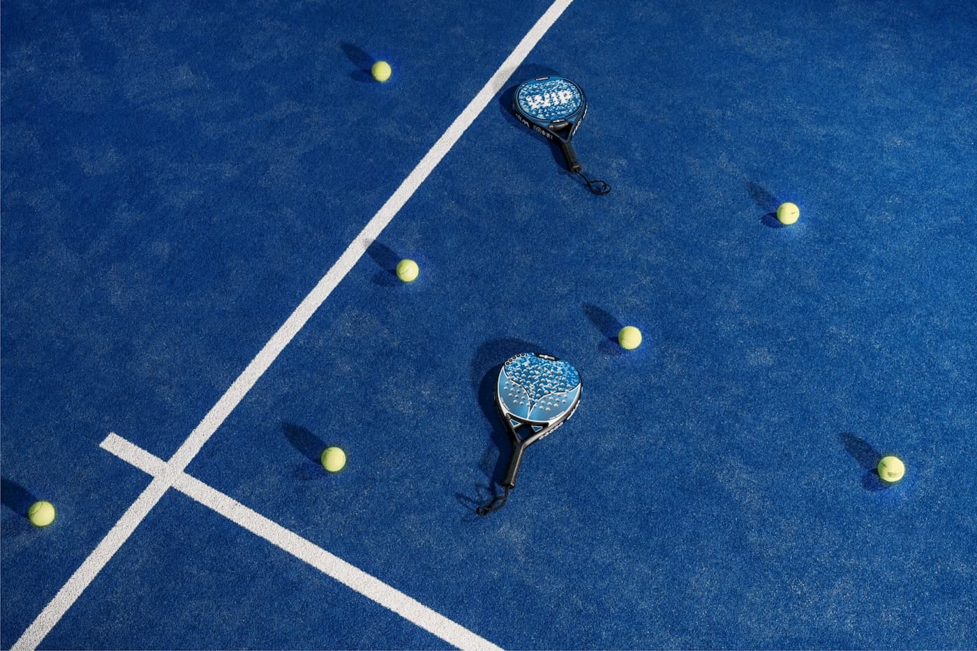 Padel rackets on a blue padel court